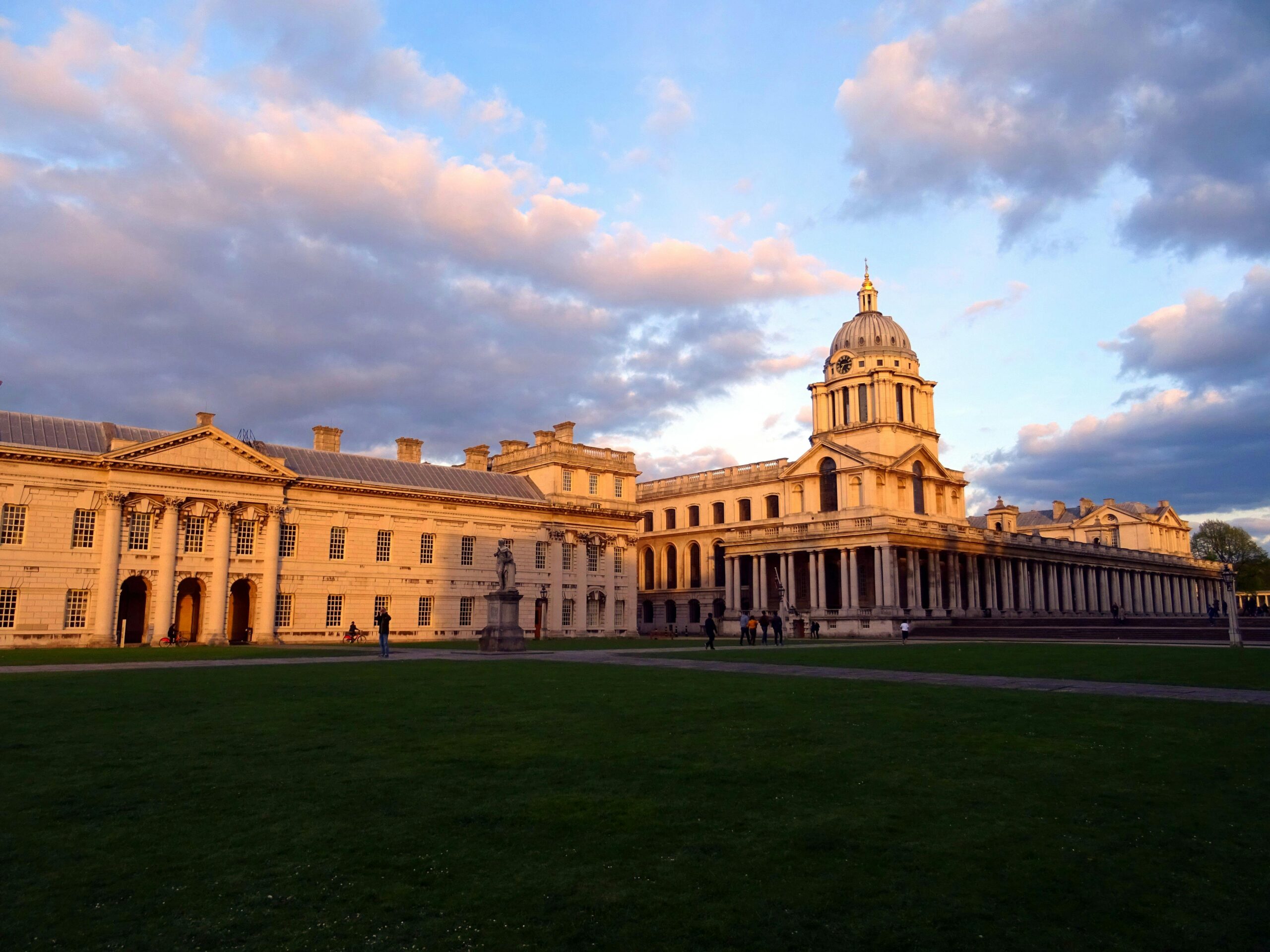 View of the Grand Greenwich architecture illuminated by sunset light with a dramatic sky.